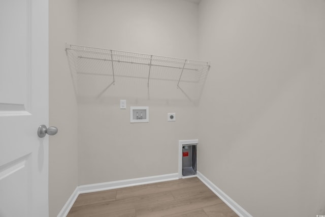 laundry room featuring electric dryer hookup, washer hookup, light wood finished floors, and baseboards