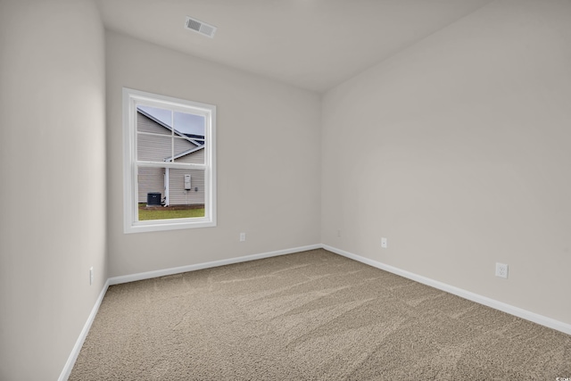 unfurnished room featuring carpet and baseboards
