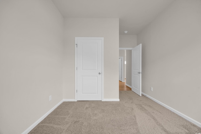 unfurnished bedroom with carpet and baseboards