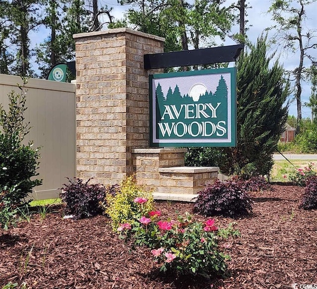 community / neighborhood sign featuring fence