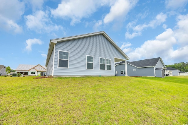rear view of house featuring a yard