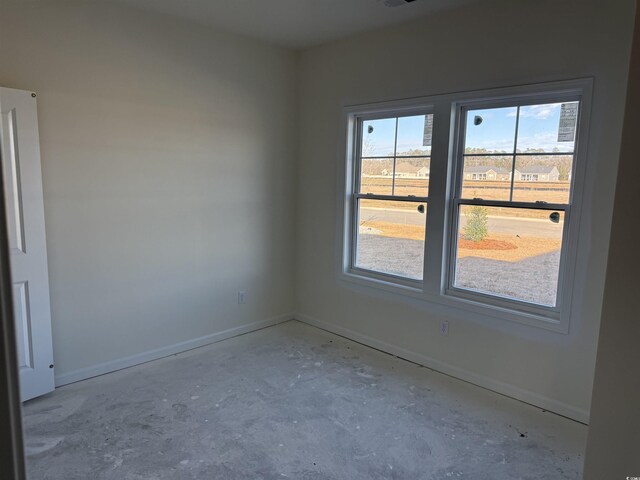 unfurnished room with concrete flooring and a healthy amount of sunlight