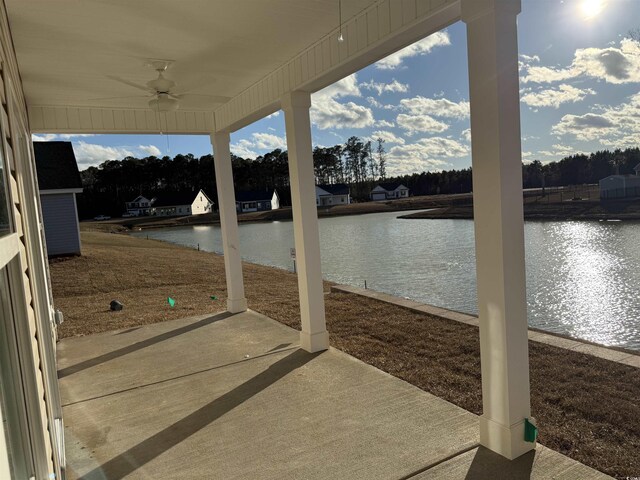 view of patio / terrace with a water view and ceiling fan