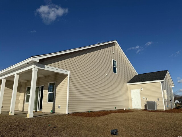 exterior space featuring a lawn and central air condition unit