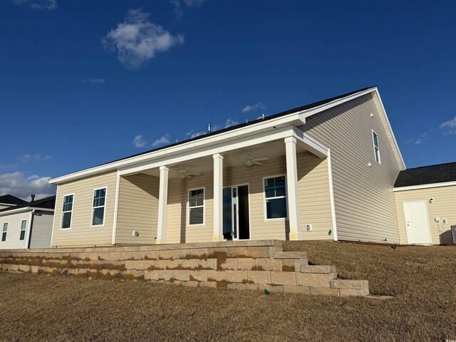 rear view of house featuring ceiling fan