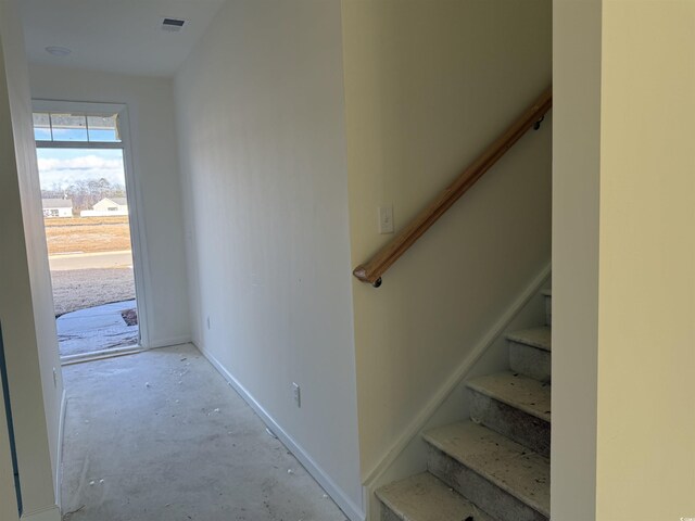 stairs featuring concrete floors