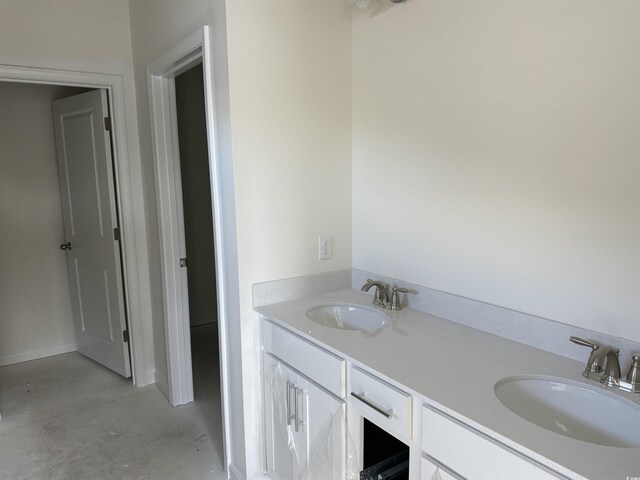 bathroom featuring vanity and concrete flooring