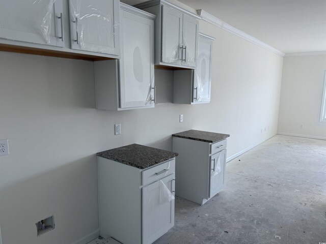 kitchen with white cabinetry and ornamental molding