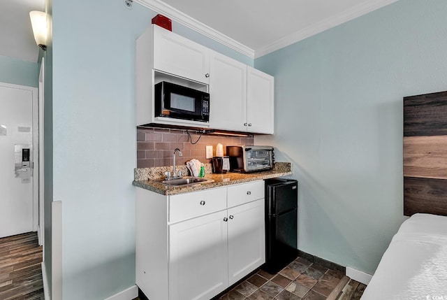 kitchen with white cabinetry, sink, backsplash, and black appliances