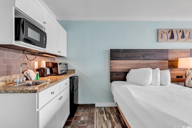 bedroom with sink and crown molding