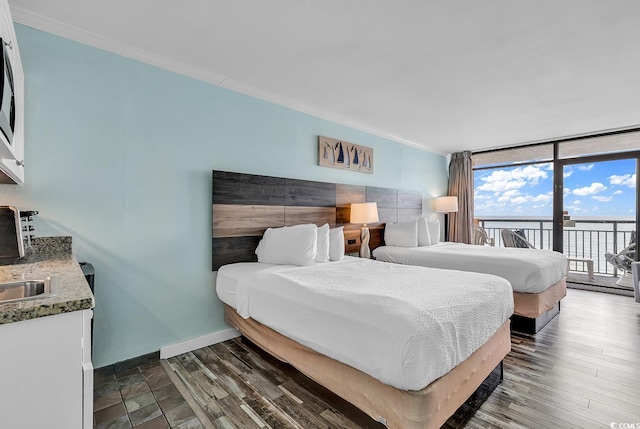 bedroom featuring ornamental molding, access to exterior, dark hardwood / wood-style flooring, and floor to ceiling windows