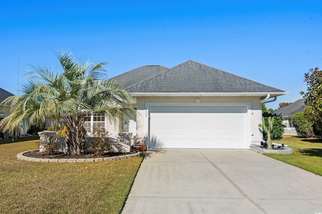 ranch-style house featuring a garage and a front lawn