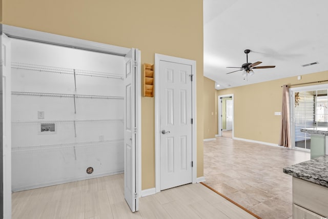 interior space featuring ceiling fan and washer hookup