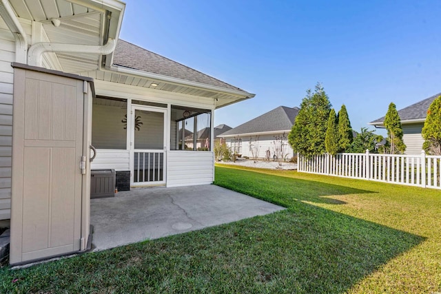 view of yard featuring a patio and a sunroom