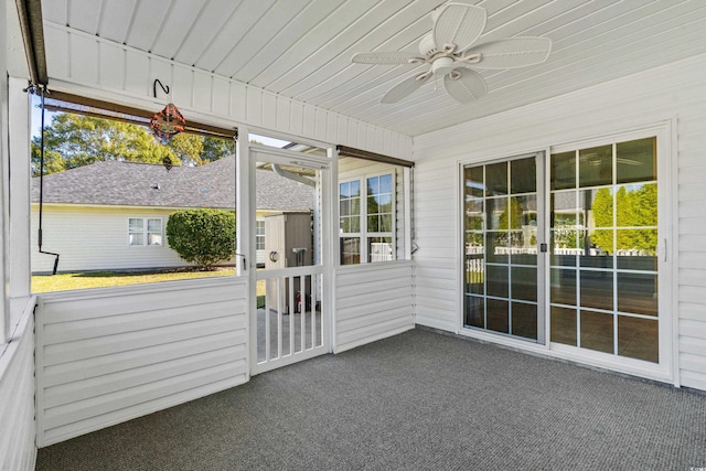 unfurnished sunroom featuring ceiling fan