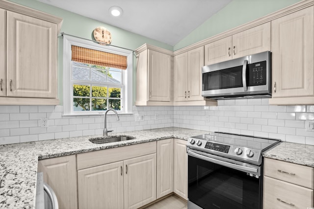 kitchen featuring decorative backsplash, sink, stainless steel appliances, and lofted ceiling