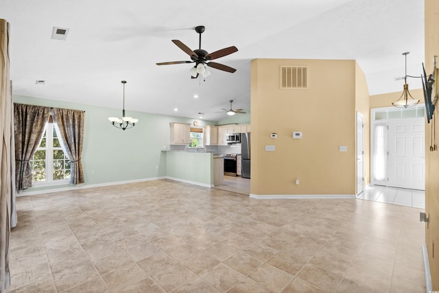 unfurnished living room with light tile patterned flooring, ceiling fan with notable chandelier, and high vaulted ceiling