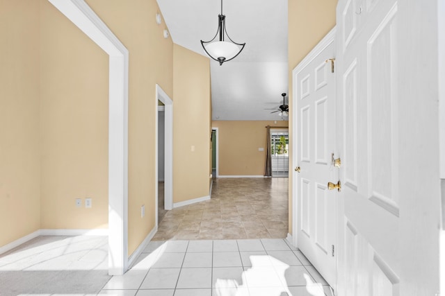 tiled foyer with ceiling fan