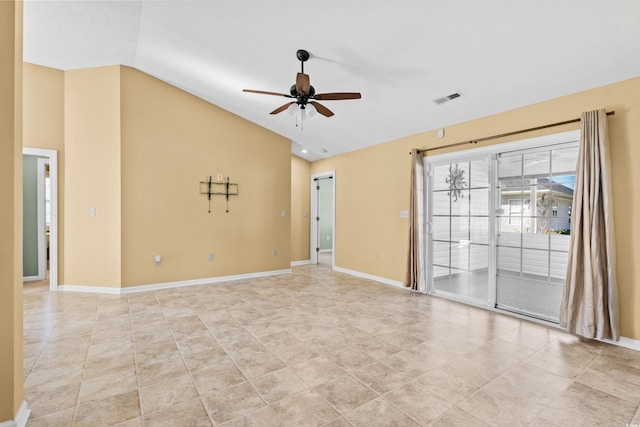 empty room featuring ceiling fan, lofted ceiling, and light tile patterned floors