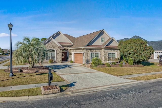 view of front of house with a garage and a front lawn