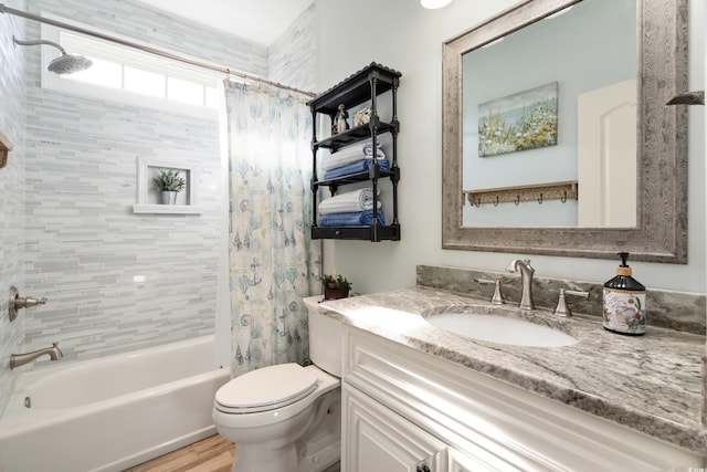 full bathroom featuring hardwood / wood-style flooring, vanity, toilet, and shower / bathtub combination with curtain