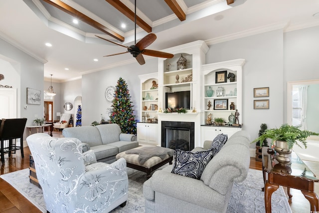 living room with beamed ceiling, wood-type flooring, and crown molding