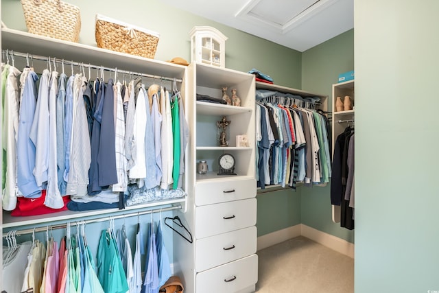 walk in closet featuring light carpet