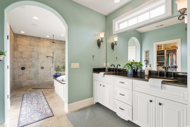 bathroom featuring tile patterned flooring, vanity, and shower with separate bathtub