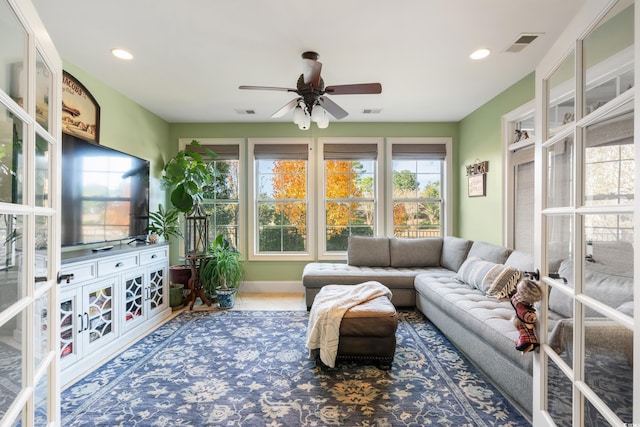 sunroom / solarium featuring ceiling fan