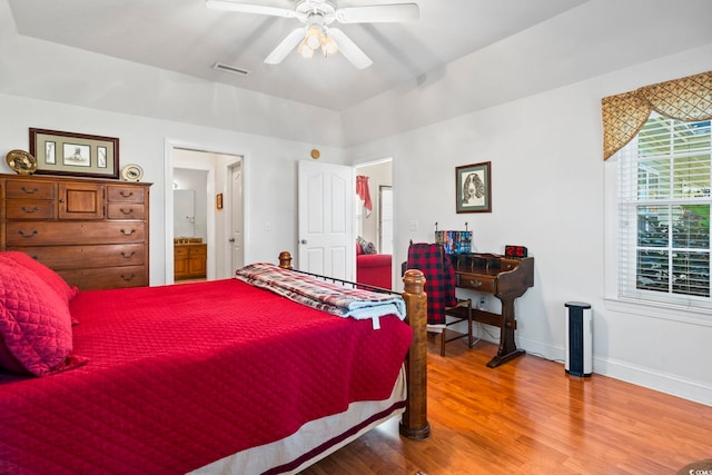 bedroom with ceiling fan, wood-type flooring, and connected bathroom