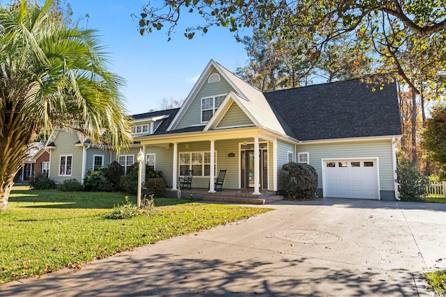 view of front of house featuring a garage, covered porch, and a front yard