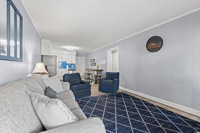 living room with hardwood / wood-style flooring and crown molding