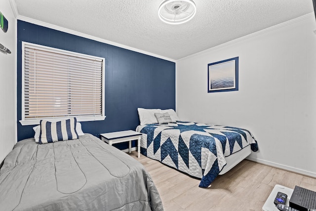 bedroom with hardwood / wood-style flooring, ornamental molding, and a textured ceiling