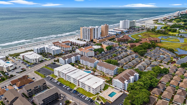 drone / aerial view with a water view and a view of the beach