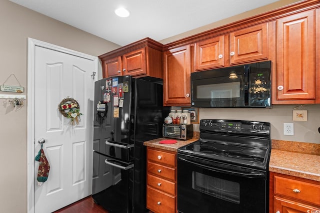 kitchen with light stone countertops and black appliances