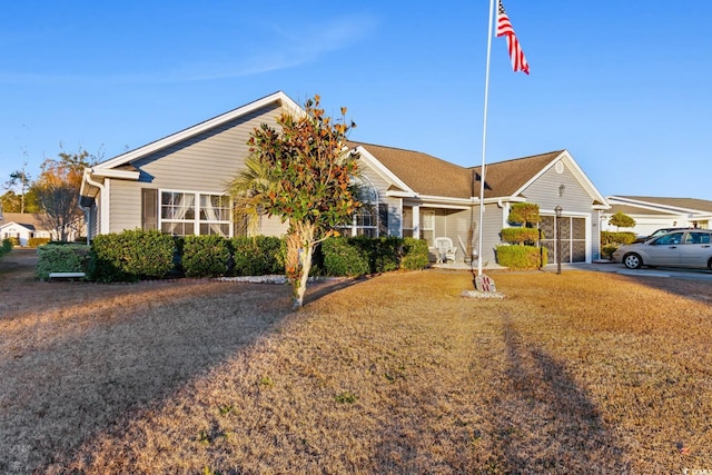 ranch-style house featuring a front lawn and a garage