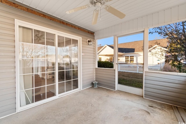 unfurnished sunroom with ceiling fan