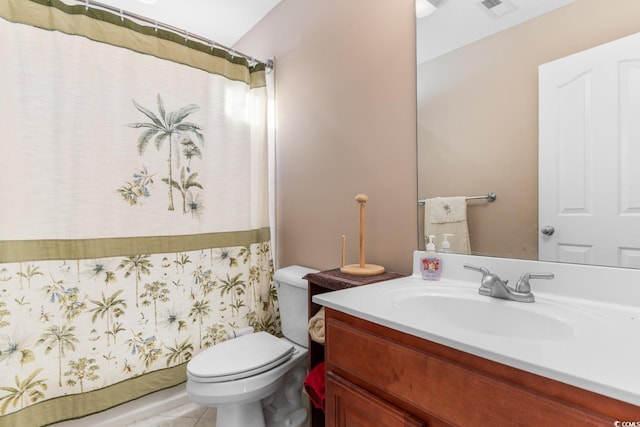 bathroom with tile patterned floors, vanity, and toilet