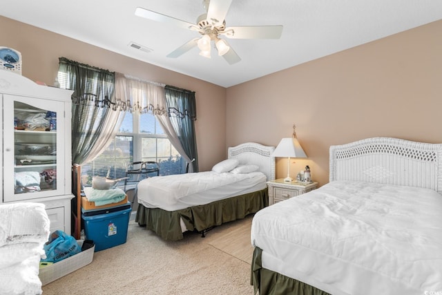 bedroom featuring light colored carpet and ceiling fan