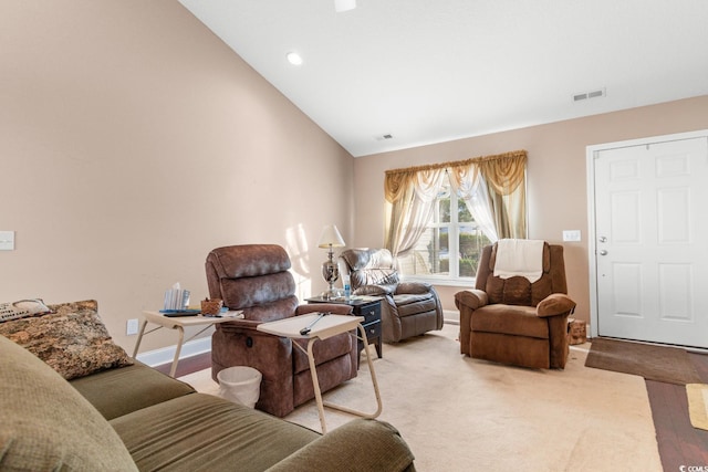 living room with light hardwood / wood-style floors and lofted ceiling