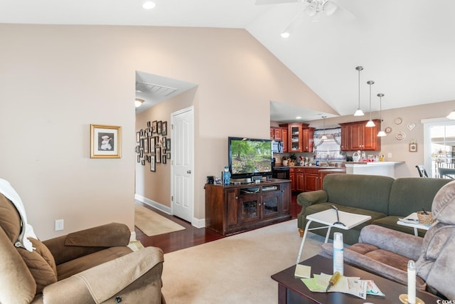 living room featuring ceiling fan, dark hardwood / wood-style flooring, and high vaulted ceiling