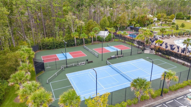 view of tennis court featuring basketball hoop