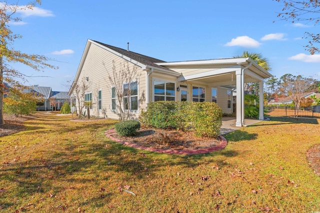 view of side of home with a lawn