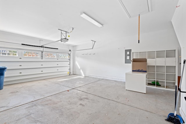 garage featuring electric panel and a garage door opener