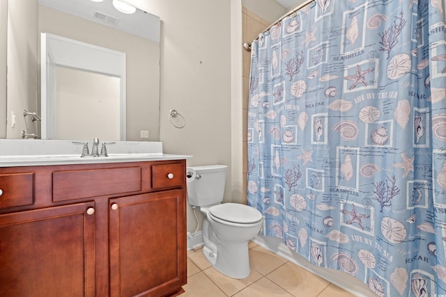 bathroom with toilet, a shower with curtain, vanity, and tile patterned floors