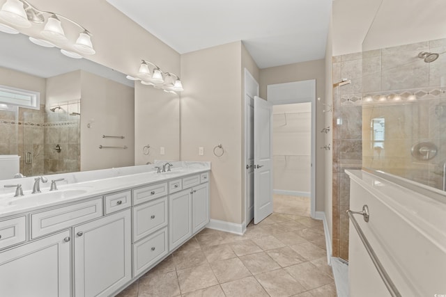 bathroom featuring tile patterned flooring, vanity, and a shower with shower door