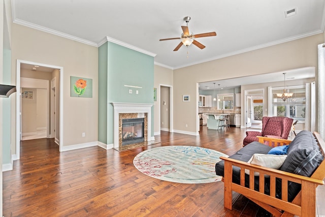 living room featuring dark hardwood / wood-style floors, a premium fireplace, and crown molding