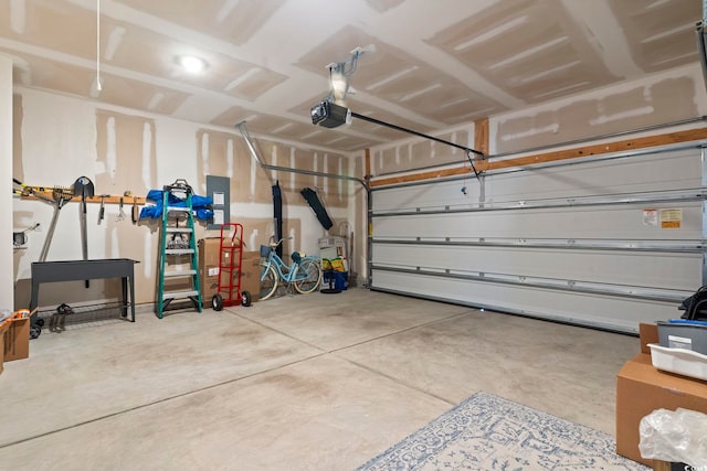 garage with electric panel and a garage door opener