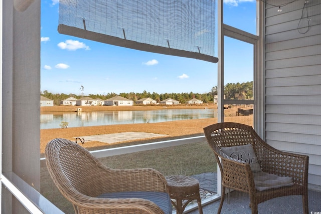 sunroom / solarium with a water view