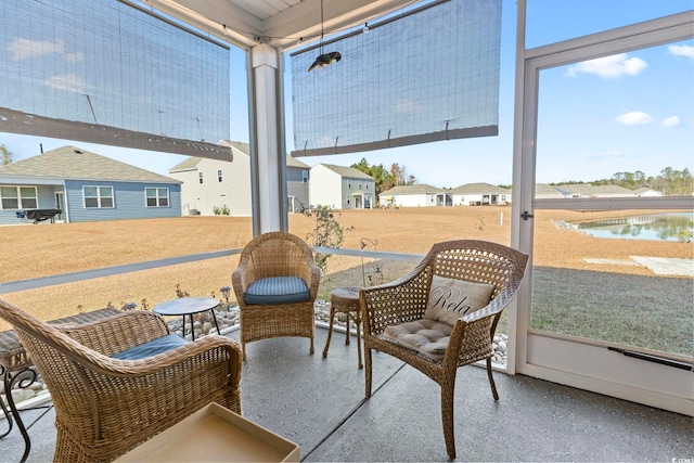 sunroom / solarium with a water view